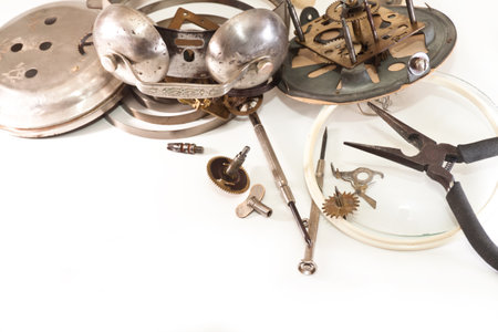 Screwdrivers, pliers, gears and springs from a mechanical alarm clock