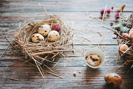 Easter composition of Easter eggs in the nest on the old wooden background. Retro vintage style. Soft focusの写真素材