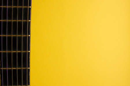 Yellow background. Guitar strings posterの写真素材