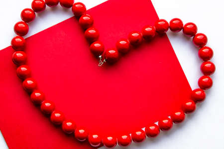 Heart made of red beads. Postcard. Place for text.の写真素材