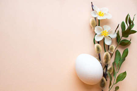 Easter poster. Egg, flowers and vellum branches on a light backgroundの写真素材