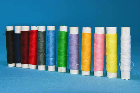 Closeup of various colored spools of thread