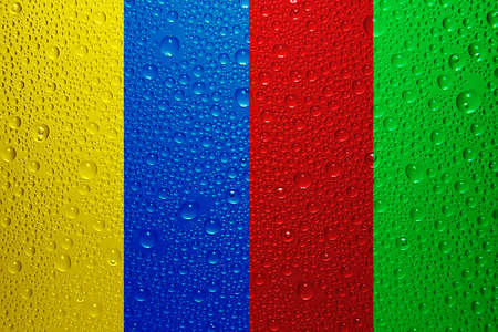 Yellow, blue, red and green water dropsの写真素材