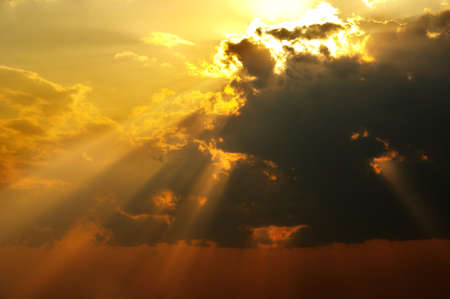 Magic solar beams coming out across clouds