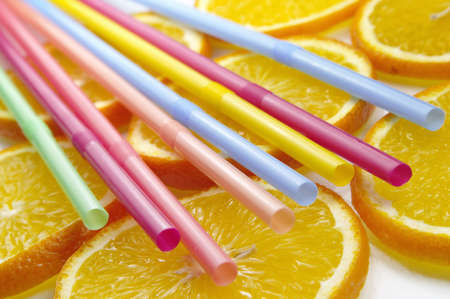 Straw on juicy citrus slicesの写真素材