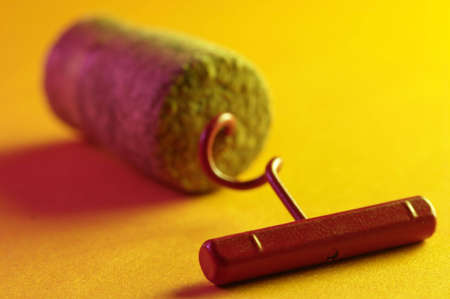Corkscrew and wine fuse on  yellow backgroundの写真素材