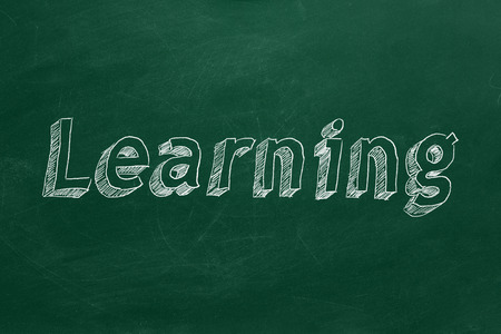 Hand drawing "Learning" on green chalkboardの写真素材