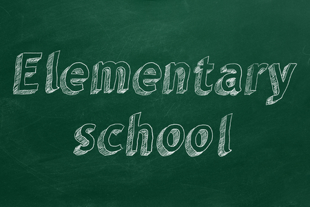 Hand drawing "Elementary school" on green chalkboardの写真素材