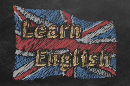 Hand drawing british flag with text LEARN ENGLISH on blackboard.の写真素材