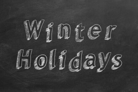 Hand drawing text Winter Holidays on blackboardの写真素材