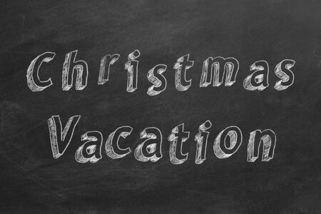 Hand drawing text Christmas vacation on blackboardの写真素材