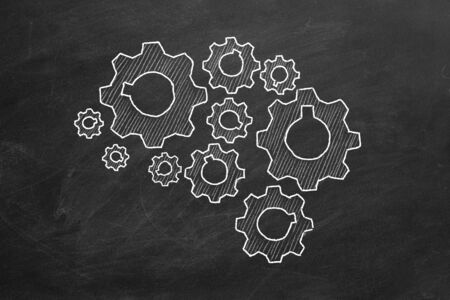 Human brain build out of cogs and gears on blackboardの写真素材