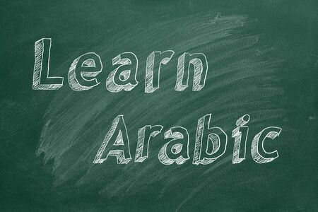 Hand drawing "Learn Arabic" on green chalkboardの写真素材