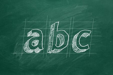 Hand drawing ABC on green chalkboard
