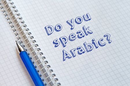 Do you speak Arabic? Text handwritten on sheet of notebookの写真素材