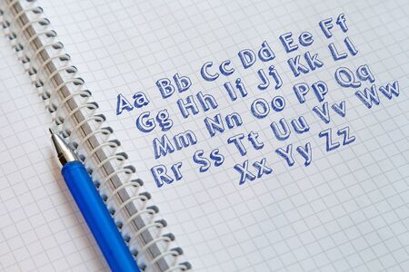 Handwritten alphabet  on sheet of notebookの写真素材