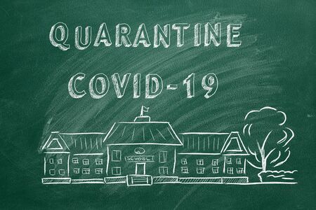 School building  and lettering Quarantine COVID-19 on green chalkboard. Hand drawn sketch. Coronavirus concept.の写真素材