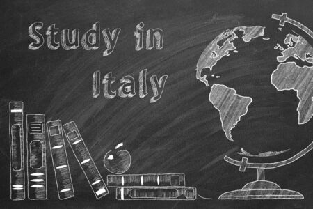Lettering "Study in Italy", globe and school books are drawn with chalk on a blackboard. Study abroad concept.の写真素材