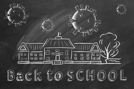 School building, coronavirus cells and lettering Back to School are drawn with chalk on a blackboard. Covid-19 concept. Start of the new school year 2020の写真素材