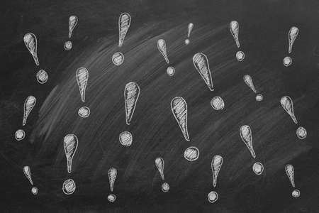 Exclamation marks drawn in chalk on a blackboardの写真素材