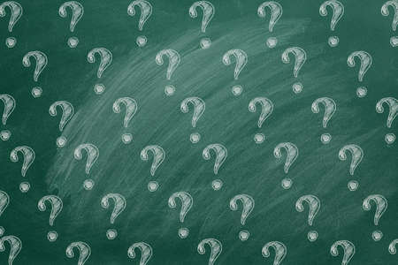 Question marks on blackboard. Ask for help. FAQ concept. Asking questions.