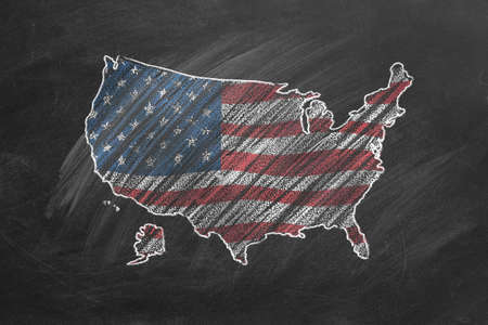 Country map and flag of the USA drawing with chalk on a blackboard. One of a large series of maps and flags of different countries. Education, travel, study abroad concept.の写真素材