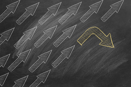 Arrows in one direction and an arrow in another direction. Business, new strategy, creative ideas, innovative solution, different opinion. Be different and unique concept. Don't follow the trend.の写真素材