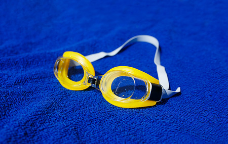 Swimming glasses at the towel. Shallow depth of field (dof).の写真素材