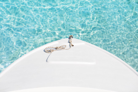 Boat bow with a rope close up. Transparent clear sea water.の写真素材