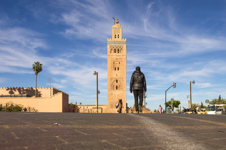 marrakech, morocco - April 5, 2014: Unidentified man walk across the street to the Koutoubia Mosqueのeditorial素材