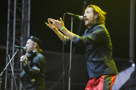 Hradec Kralove, CZECH REPUBLIC - JULY 3, 2013: Violin player Sergey Ryabtsev (left) and singer Eugene Hutz (right) of Gogol Bordello During a performance at Rock for People festival in Hradec Kralove, Czech Republic, July 3, 2013.のeditorial素材