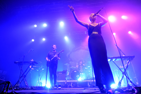 Hradec Kralove, CZECH REPUBLIC - JULY 5, 2014: Guitarist Thom Powers (L), drummer Jesse Wood (C) and lead singer Alisa Xayalith (R) of The Naked and Famous During a performance at the Rock for People festival in Hradec Kralove, Czech Republic, July 5, 201のeditorial素材