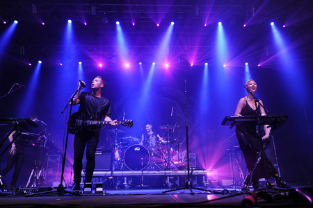 Hradec Kralove, CZECH REPUBLIC - JULY 5, 2014: Guitarist Thom Powers (L), drummer Jesse Wood (C) and lead singer Alisa Xayalith (R) of The Naked and Famous During a performance at the Rock for People festival in Hradec Kralove, Czech Republic, July 5, 201のeditorial素材