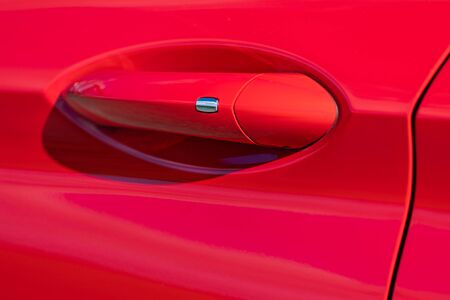 Door handle of modern red carの写真素材