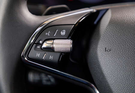Buttons on steering wheel in interior of a car