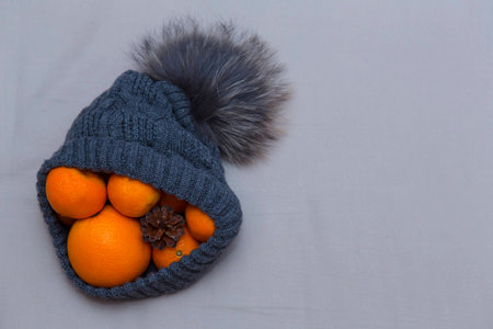 Cap with mandarins oranges and conesの写真素材