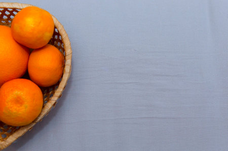 Mandarins in a wicker basket with a place for writingの写真素材