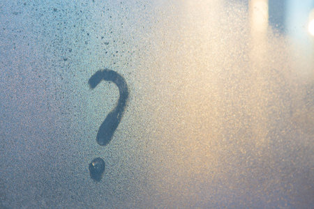 Question mark on the frozen winter glassの写真素材