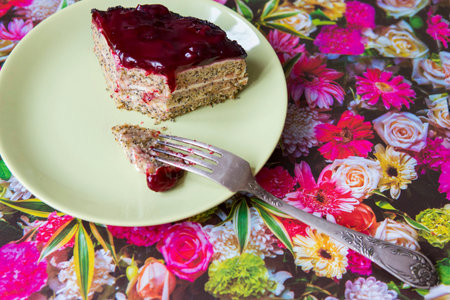 A piece of poppy cherry cake with a fork on a green plate. Healthy diet and diet. Compliance with diet.の写真素材