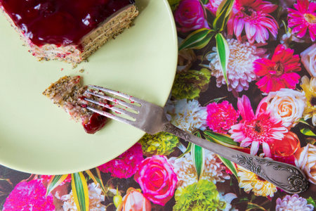 A piece of poppy cherry cake with a fork on a green plate. Healthy diet and diet. Compliance with diet.の写真素材