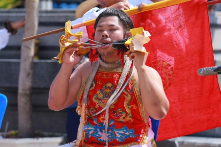 Nakhon Ratchasima, THAILAND - OCT 8  An unidentified devotee of Vegetarian Festival, person who invites the spirits of gods to possess their bodies on October 8, 2013 in Nakhon Ratchasima, Thailand のeditorial素材
