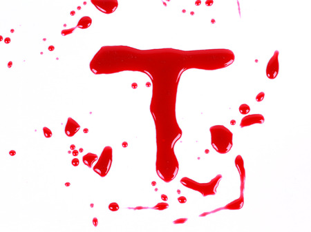 Bloody print on a white background with the letters Tの写真素材