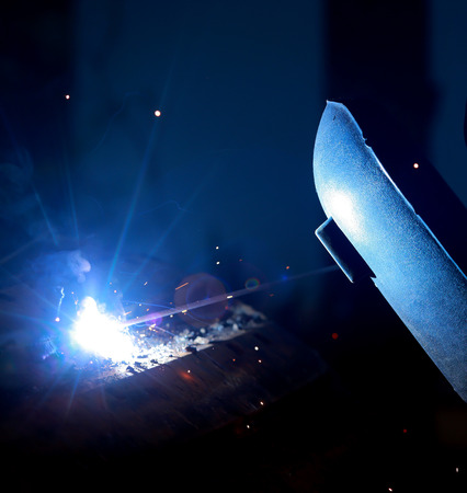 Close-up of welder working in workshop.