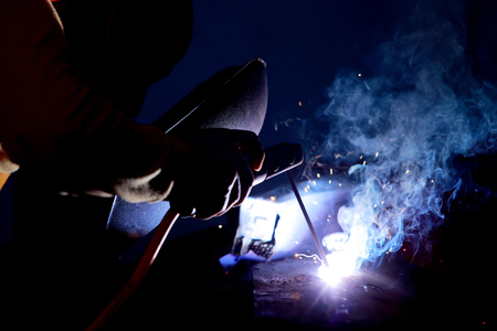 Close-up of welder working in workshop.