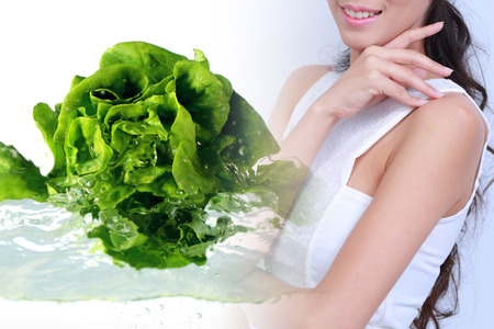 Happy, healthy women to lose weight .Vegetables and fruit in the background .の写真素材