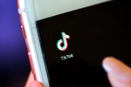 Nakhonratchasima, Thailand - May 31, 2020 : Tik Tok application on iPhone 8, finger about to touch it.which is a popular social media network is app to create and share videos on the internet.のeditorial素材