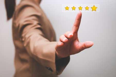 Customer pressing satisfaction with gold five star rating feedback icon and press level excellent rank for giving best score point to review the service , experience success business rate  concept.の写真素材