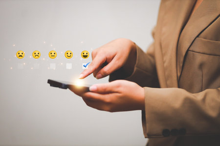 Customer pressing satisfaction with gold five star rating feedback icon and press level excellent rank for giving best score point to review the service , experience success business rate  concept.の写真素材