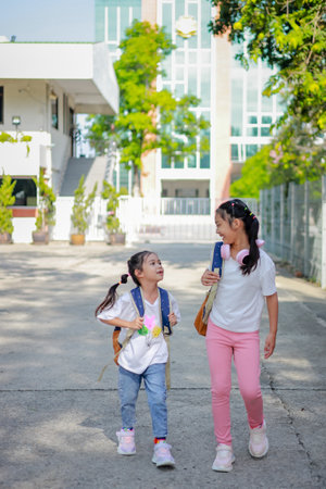 Little kid girl asian with a backpack going to school with fun. which increases the development and...