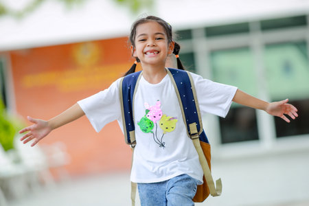 Little kid girl asian with a backpack going to school with fun. which increases the development and enhances the learning skills. Concept Back to school.の写真素材